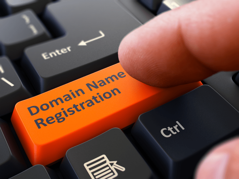 Finger Presses the Button Domain Name Registration on Black Keyboard - How to Register a Domain Name?